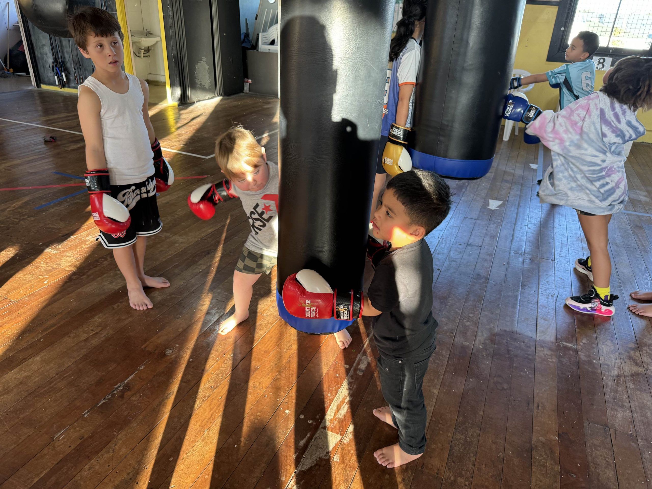 Tamariki working the heavy bags in the hall at the EP Fitness and Wellbeing Hub.