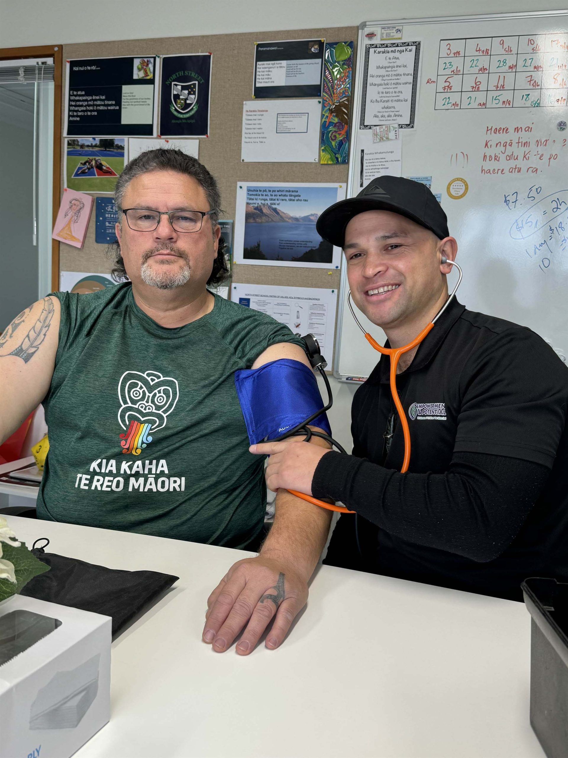 Josh Te Rauna taking a blood pressure reading for a participant.
