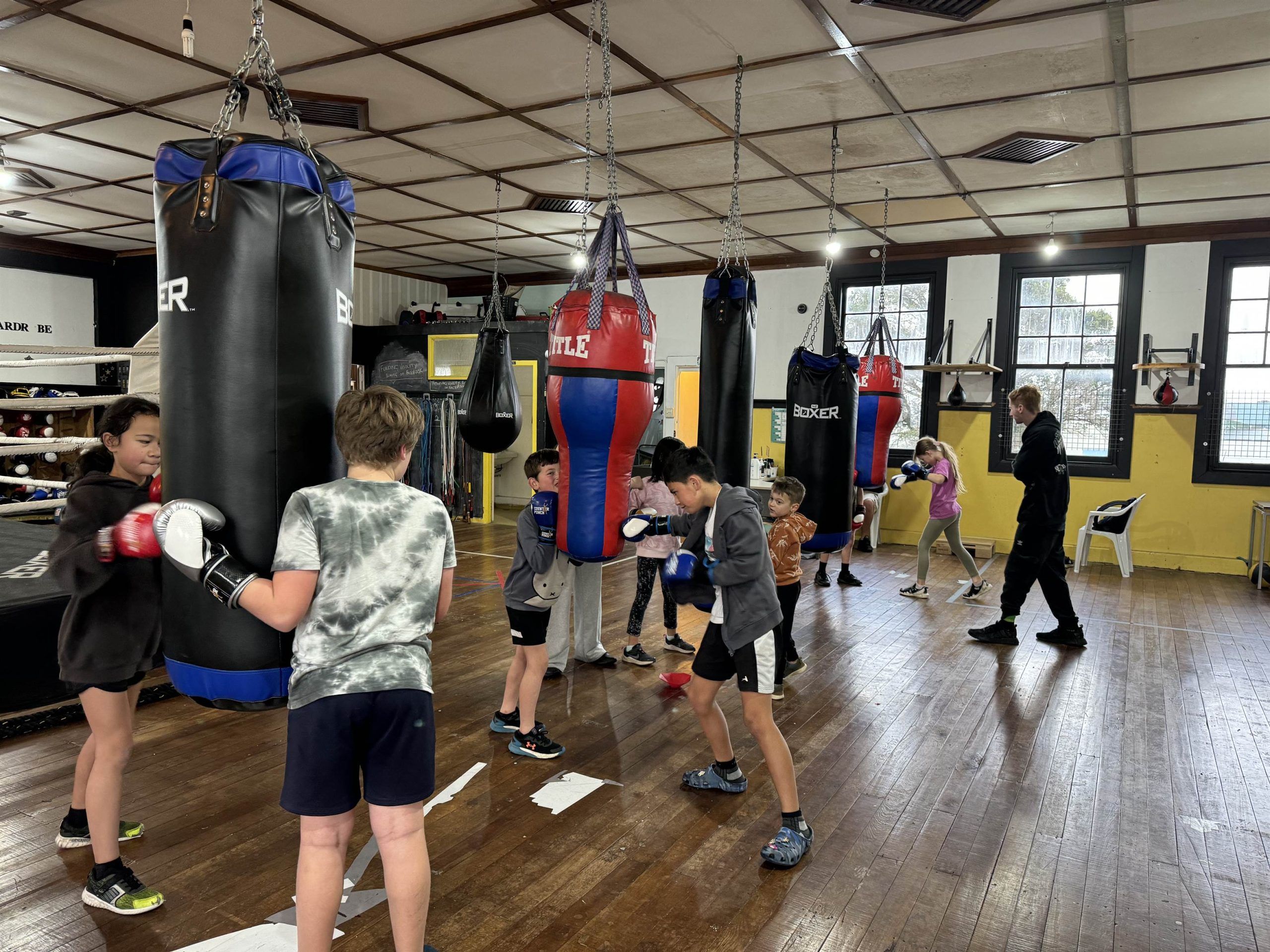 The hall at the EP Fitness and Wellbeing Hub, tamariki spread across the bags.